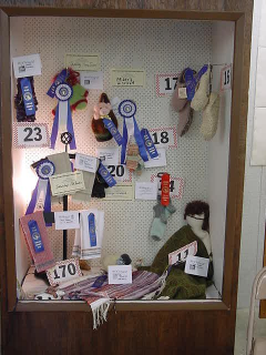 Display case full of items with fair ribbons