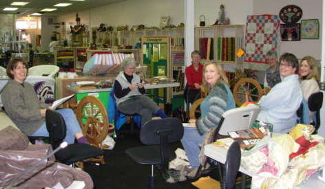 Circle of women in colorful quilt shop